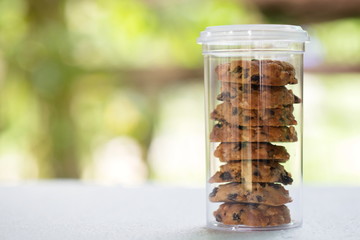 Bakery cookie in plastic jar packaging on table.