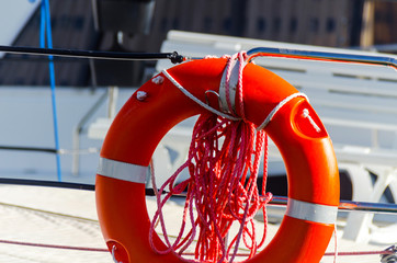 Orange lifebuoy on the side of the boat, an essential tool life-saving at sea
