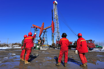 Oil field oil workers at work