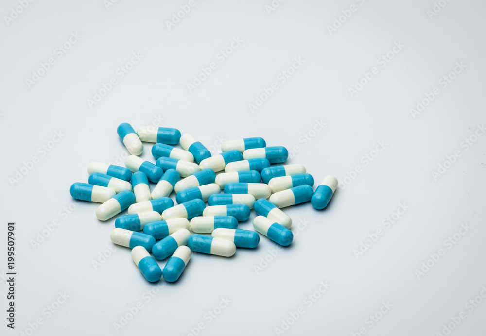 Wall mural blue and white capsules pills isolated on white background with copy space for text. global healthca