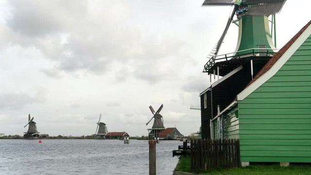 a close up of a green windmill at zaanse schans near amsterdam in the netherlands