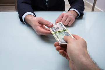 Person Giving Bundle Of Banknote