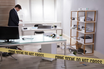 Investigator Collecting Evidence In Office