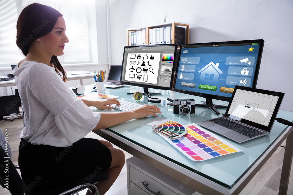 Poster female designer working on multiple computer