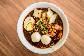 Top view of Chinese chopsticks eating noodle, a famous Malaysia prawn noodle cerry soup.