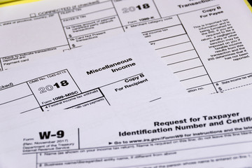 Shot of IRS tax forms 1099-M, 1099-K and W-9