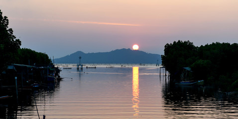 The sun fell into the water at the lake in the evening   