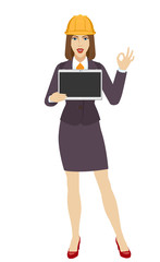 Businesswoman in construction helmet holding a digital tablet PC and showing a okay hand sign