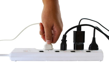 Hand holding electric plug, Multiple socket with connected plucgs. Isolated on white background with clipping path..