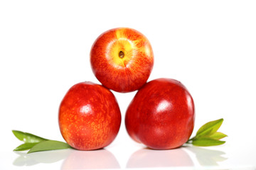 Peach. three ripe peaches on a white background with reflection. Peach season