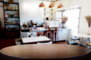 Selected focus empty brown wooden table and Coffee shop or restaurant blur background with bokeh image. for your photomontage or product display.