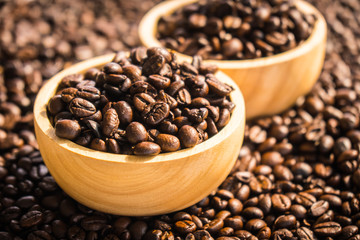 Brown coffee beans in wood bowl