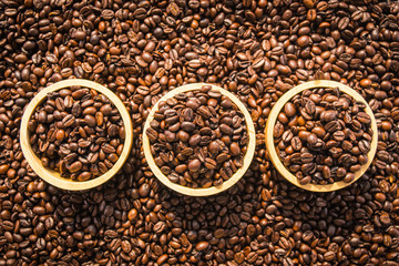 Brown coffee beans in wood bowl