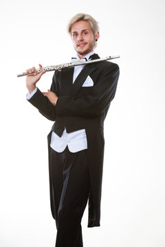 Male flutist wearing tailcoat holds flute
