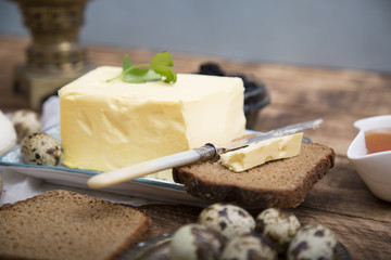 Breakfast table with bread slice, butter, black caviar, milk and honey 