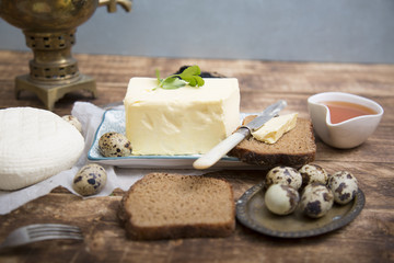 Breakfast table with bread slice, butter, black caviar, milk and honey 