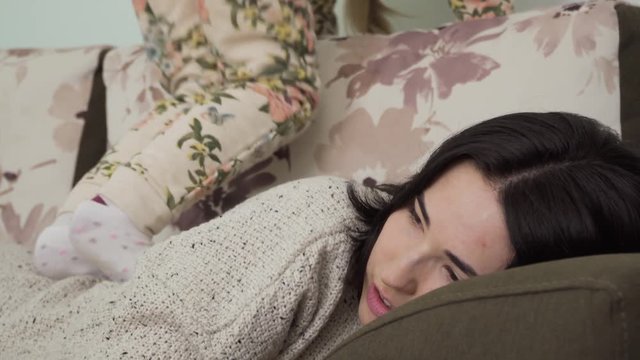 Little girl makes massage of the back of her mother walking on her
