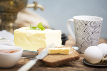 Breakfast table with bread slice, butter, black caviar, milk and honey 