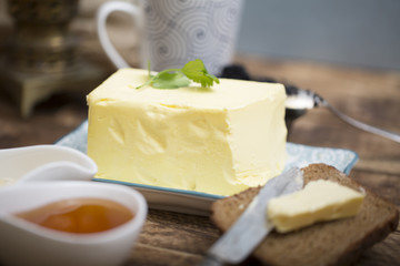 Breakfast table with bread slice, butter, black caviar, milk and honey 