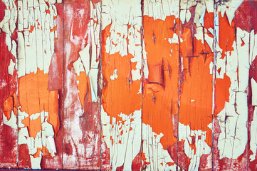 The wooden background is painted white, orange and brown with cracks and scratches. Abstract background.