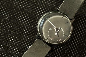watch lying on dark background