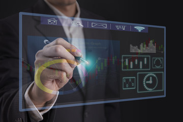 Businessman wearing suit hand holding pen pointing on a touch virtual screen interface icon connection , concept business connection