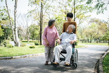 cheerful disabled grandfather in wheelchair welcoming his happy Family