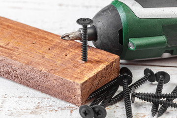 screw screwed into a wooden bar