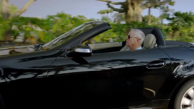 Carefree Senior Man Drives Past Lake In His Luxury Convertible, In Sunny Florida - Shot On Red Scarlet-W Dragon In 4K/ Slow Motion