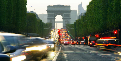 Long exposure photo of street traffic near Arc de Triomphe, Champs Elysees boulevard. Paris, France