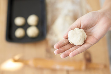 Piece dough in girl hand. Home kitchen