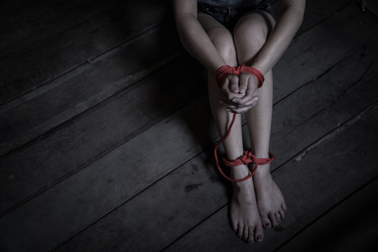 Victims of abducted women get wrists and feet in red..Hostage concept or female kidnapped from robber.
