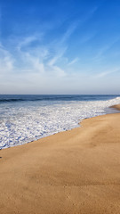 Sea surf on the beach on a sunny day
