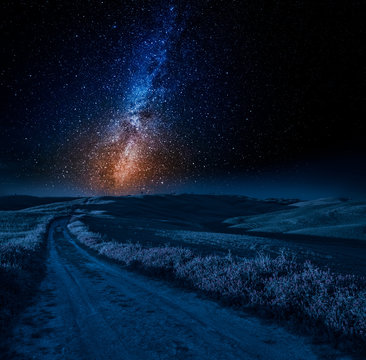 Stunning milky way, road and fields in Italy