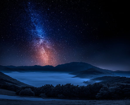 Milky way and foggy valley in Castelluccio, Italy, Umbria