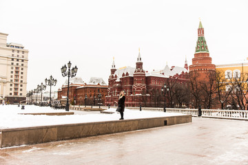 Fototapeta premium Portrait in full growth, Russian beautiful woman in a mink coat on the Red Square in Moscow in Christmas time