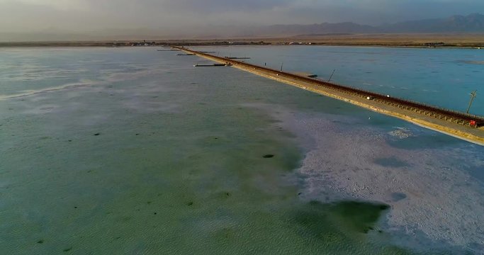 Flying over Chaka Salt Lake. A thin film of salt water covers the thick salt crust punctured by holes which reach deep into the lake. Tibetan plateau, Qinghai Province, China.