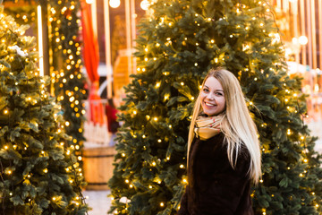 Portrait in full growth, Russian beautiful woman in a mink coat on the Red Square in Moscow in Christmas time