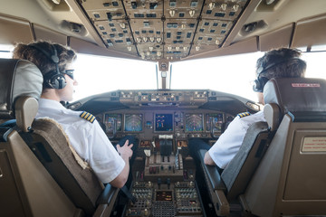 Piloten im Cockpit steuern das Flugzeug 