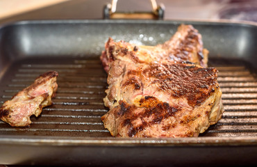 Large piece of fresh beef meat steak prepared on a grill pan.