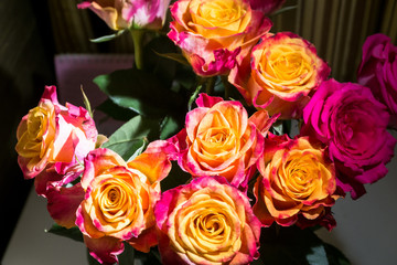 Festive bouquet of fresh roses with original yellow and crimson coloration.