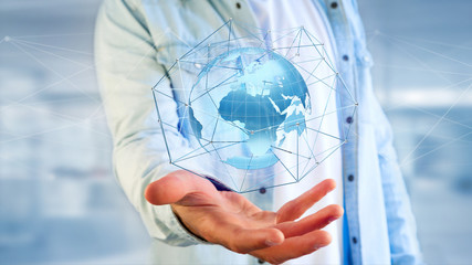 Businessman holding a Connected network over a earth globe concept on a futuristic interface - 3d rendering