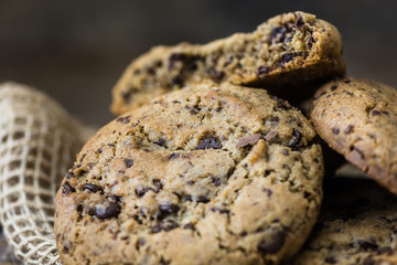 A Heap of Freshly Baked Chocolate Cookies on Rustic Wooden Table. Sweet Biscuits. Homemade pastry.