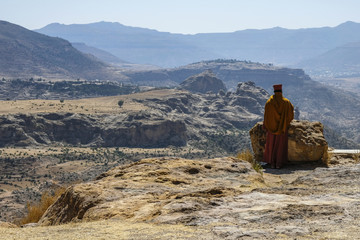 Priest looking over scarp at monastery Debre Damo, near Adigrat in Tigray Region, Ethiopia.
