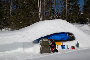 Man is sleeping in a snow cave, cross section