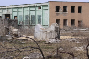 Destroyed industrial brick building. Industrial waste and debris environmental pollution. Scattered...