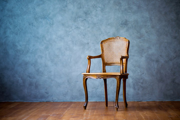 old chair on a gray wall background.