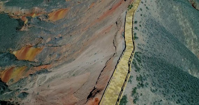 Flying over wooden walkway on crest of Zhangye Rainbow Mountains