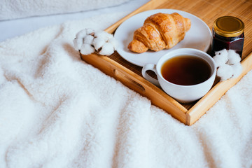Coffee and croissant in bed