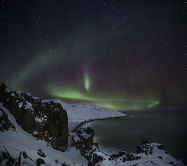 Fototapeta na wymiar Northern Lights on the coast of the Barents Sea